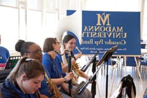 a few members of the pep band conversing and laughing between songs